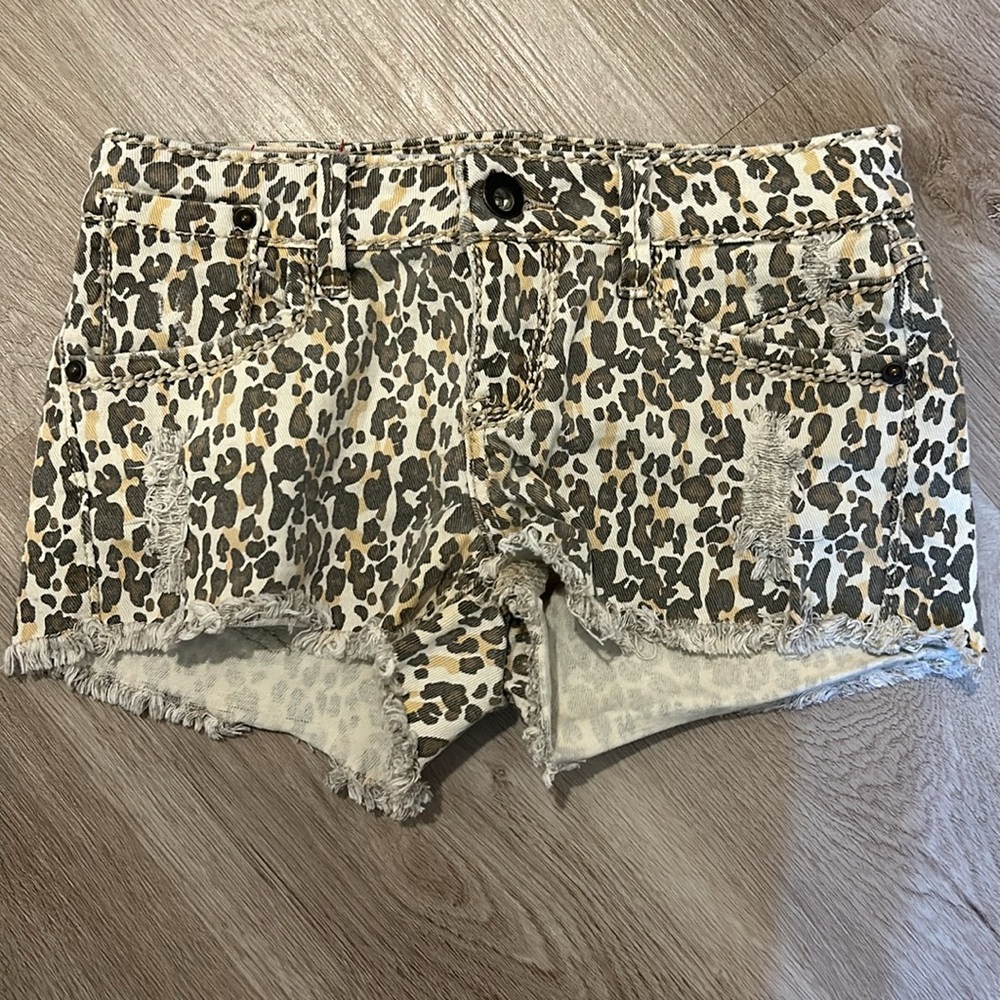 Low rise distressed denim cheetah micro shorts